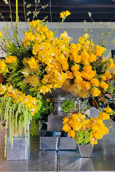 Lobby Focal Flowers in Bright Yellow Hues | Hotel flowers, Yellow flower arrangements, Hotel ...