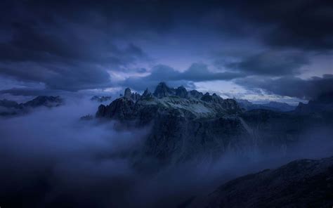 Download Caption: A Majestic Dark Mountain Against a Starry Night Sky Wallpaper | Wallpapers.com