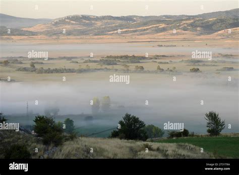 misty morning on Gatacko Polje, karstic field within the Gacko municipality, Bosnia and ...