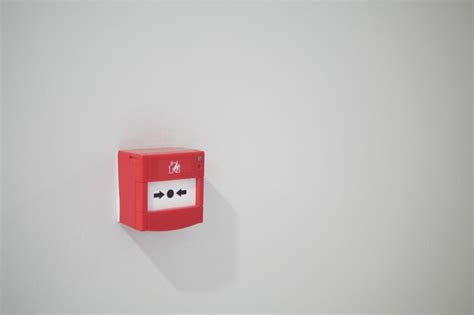 Premium Photo | Red fire alarm button on wall