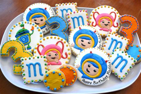 decorated cookies on a plate with the names of zodiacs and numerals in them