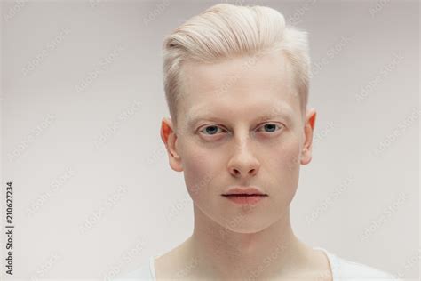 Fashion albino model man portrait isolated on white background. Stylish haircut, perfect skin ...