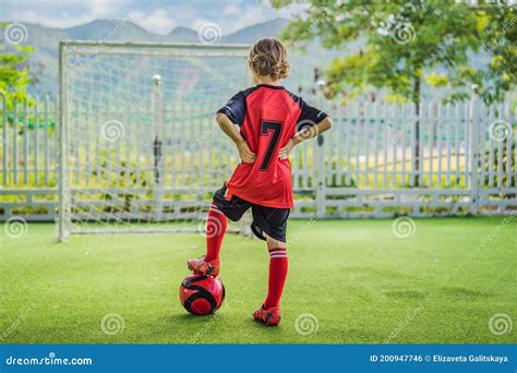 Little Cute Kid Boy in Red Football Uniform Playing Soccer, Football on ...