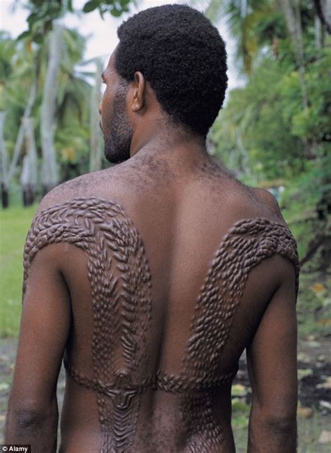 A man is pictured sporting skin decorations that pay tribute to ...