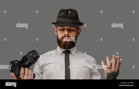 A man with dslr isolated on grey background Stock Photo - Alamy