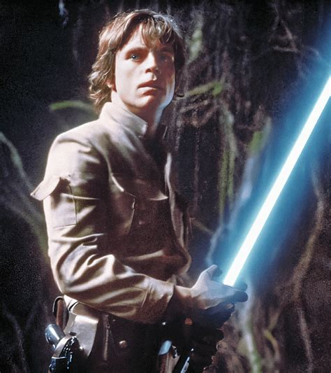 Luke Skywalker plays with fire, hand hovering over lightsaber blade, in Empire Strikes Back ...