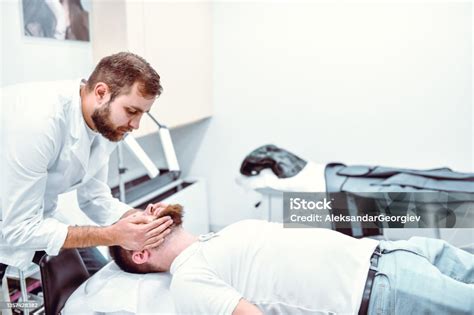 Doctor Using Massage Treatment To Relieve Inflamed Sinuses Of Male ...