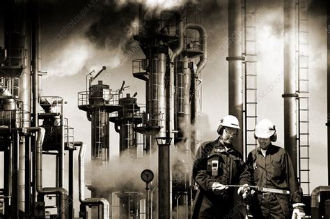 Oil refinery workers and pipework - Stock Image - F018/0894 - Science Photo Library