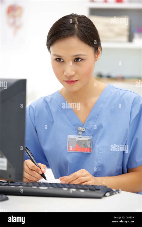 Young hospital doctor at desk Stock Photo - Alamy