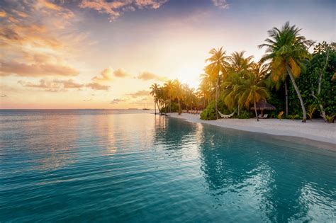 Sunrise behind a tropical island in the Maldives - RIU.com | Blog