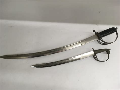 Two Indian curved swords with engraved blades