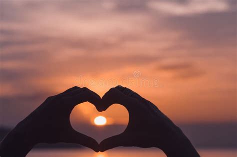 Hands Forming A Heart Shape With Sunset Stock Photo - Image of person ...