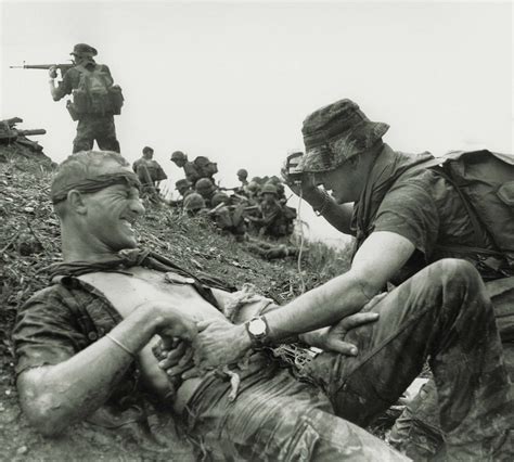 A medic attends a wounded Special Forces soldier as South Vietnamese ...