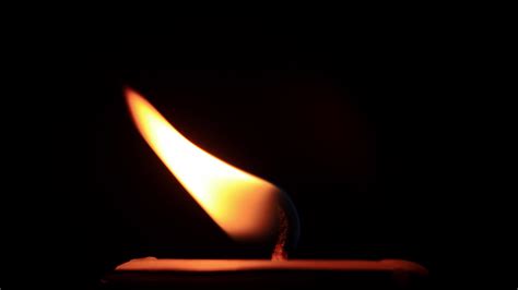 Candle flame on black background 5879437 Stock Video at Vecteezy