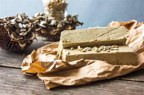 Premium Photo | Halva. sunflower halva with seeds on wooden background. festive oriental delicacy