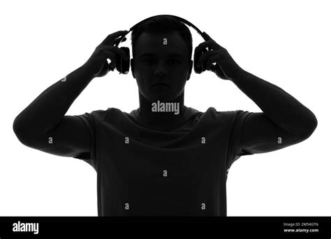 Silhouette of young man in headphones on white background Stock Photo ...