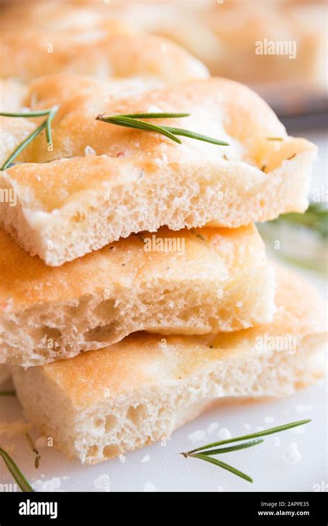 Simple plane pizza with rosemary and salt cut in pieces Stock Photo - Alamy