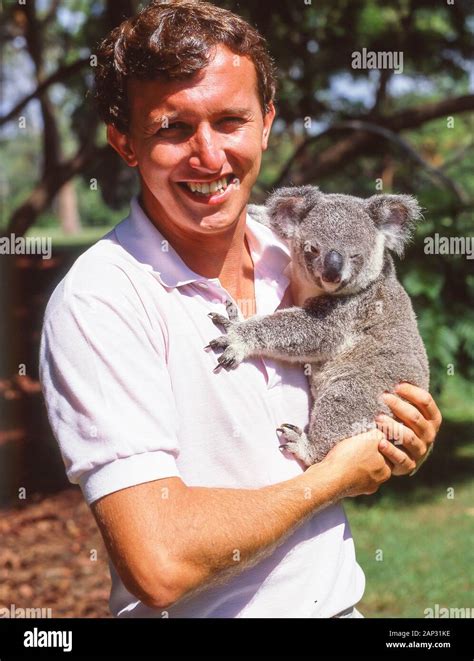 Young man holding Koala at Lone Pine Koala Sanctuary, Fig Tree Pocket ...