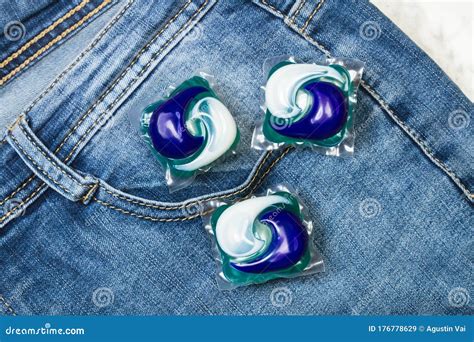 Three Washing Machine Detergent Pods on a Blue Jeans Stock Image - Image of object, machine ...