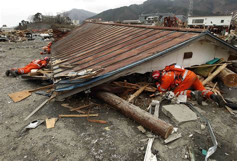 Search and rescue worders search for survivors following the 2011 tsunami that struck Japan ...