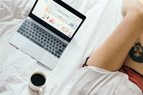 Crop woman using laptop in bed at home · Free Stock Photo