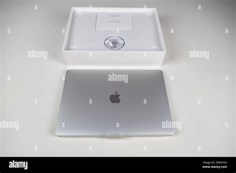 Unboxing a silver macbook air on a white table. Apple laptop Stock ...