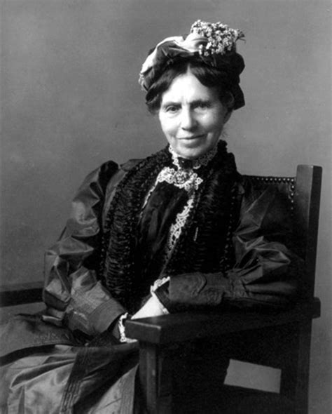 an old black and white photo of a woman sitting in a chair