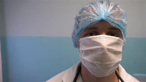 Close Up Of A Female Surgeon's Face Wearing Surgical Mask Stock Footage Video 9871007 | Shutterstock