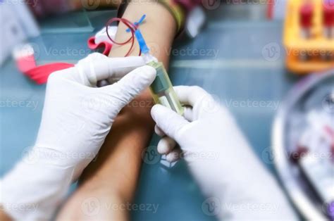 Phlebotomist detecting median cubital vein or cephalic vein to place needle for collecting blood ...