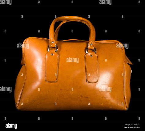 Old vintage luggage brown bag. Black isolated Stock Photo - Alamy
