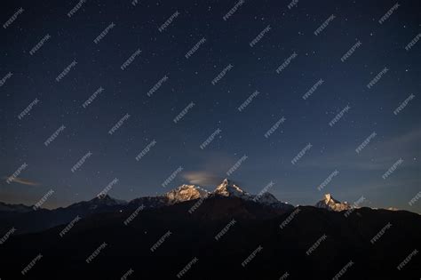 Premium Photo | A starry night sky over the mountains