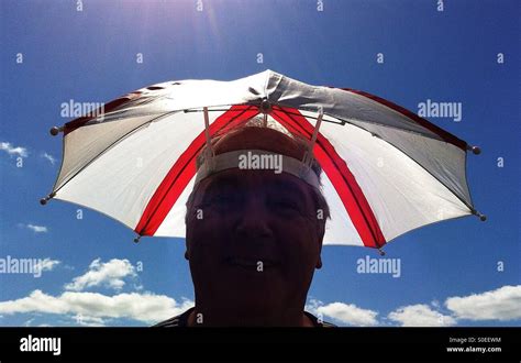 Umbrella hat man Stock Photo - Alamy