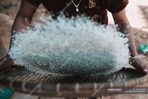 Crop woman winnowing rice in basket — anonymous, cute - Stock Photo | #189084706