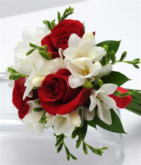 This bouquet has three sensational roses surrounded by beautiful mixed greenery and matching ...