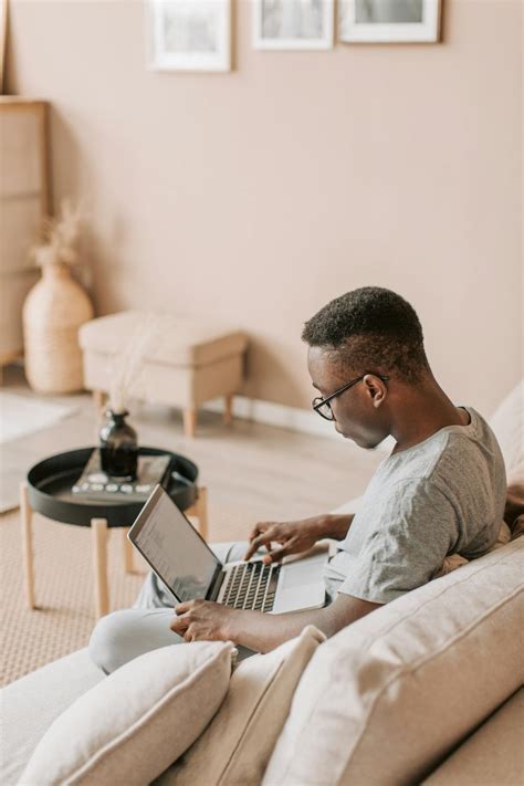 Photo of a Man Sitting on Sofa While Using Laptop · Free Stock Photo