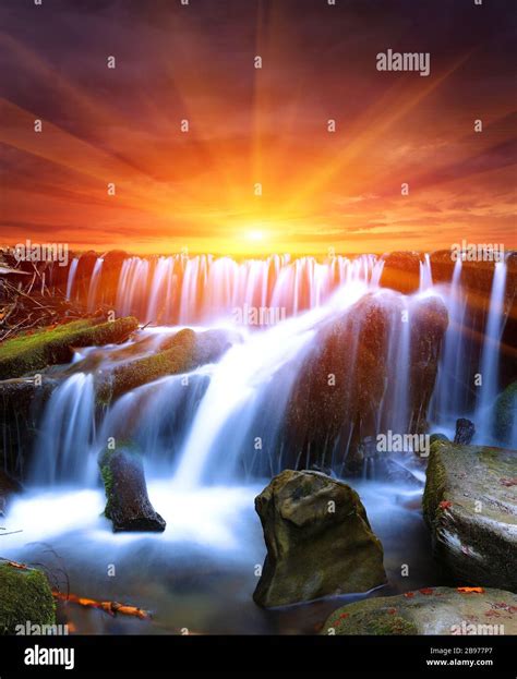 Nice sunset scene with waterfall Stock Photo - Alamy