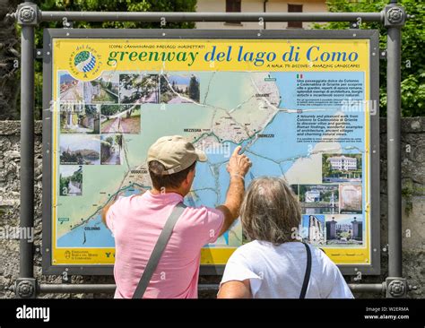 LENNO, LAKE COMO, ITALY - JUNE 2019: People looking at a map of the ...