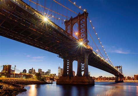 the new york city skyline and manhattan bridge at sunset, manhattan in ...