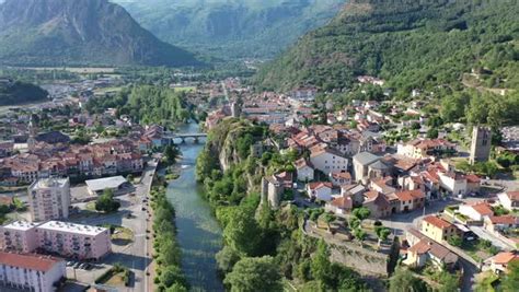 General aerial view of small French town of Tarascon-sur-Ariege in valley of Pyrenees on banks ...