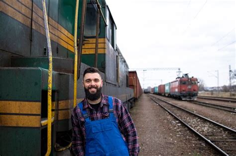 Premium Photo | Portrait of engine train driver standing by locomotive ...