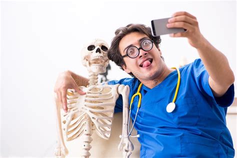 The Funny Doctor with Skeleton in Hospital Stock Photo - Image of funny, anatomy: 129757808