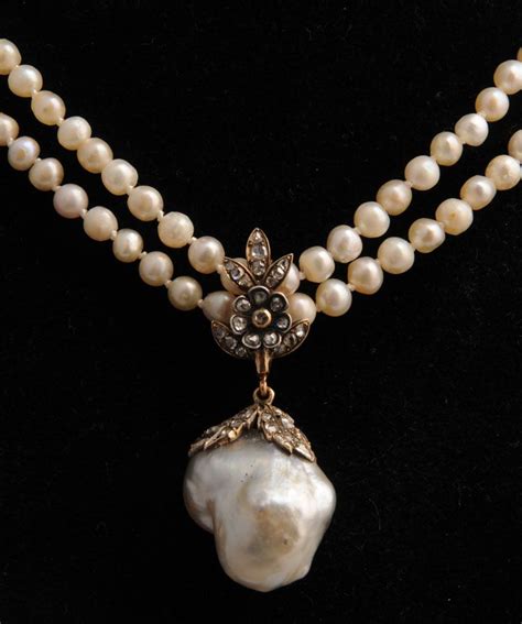 An Antique baroque natural pearl and diamond pendant on a natural pearl necklace | Pearls ...