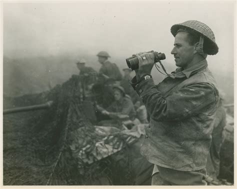 Members of the South African 6th Armored Division with camoflagued artillery in Italy in ...