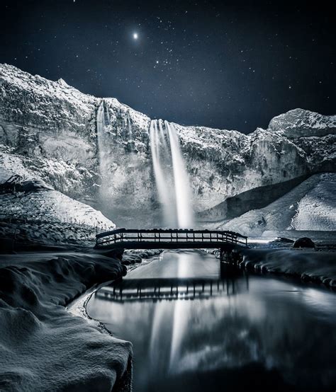 snowy, wintry scene at southern Iceland’s Seljalandsfoss waterfall ...