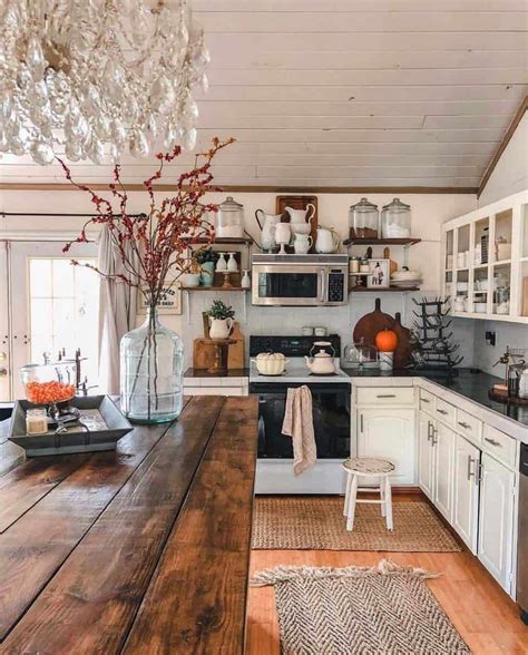 This cozy farmhouse kitchen is styled for fall with orange accents. Simple decorations includes ...