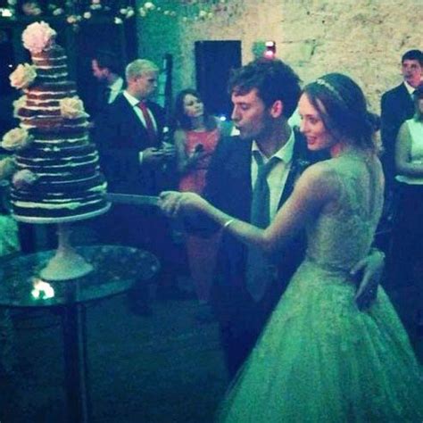 a bride and groom are cutting their wedding cake at the reception in an ...