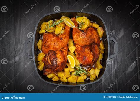 Baked chicken on potatoes stock image. Image of bake - 49669457