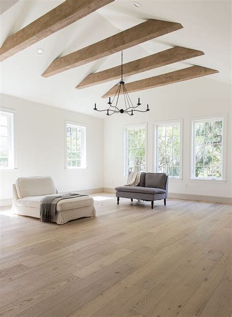 Expansive modern living room with vaulted ceiling and exposed beams ...