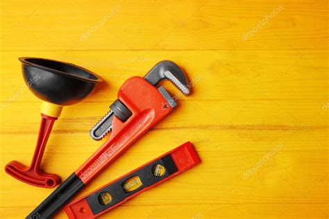 Plumber tools on yellow wooden background — Stock Photo © belchonock #124919784