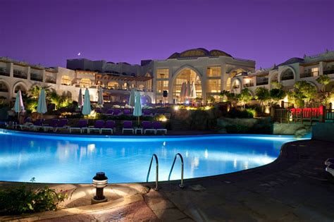 Resort Pool At Night Stock Photo - Download Image Now - iStock